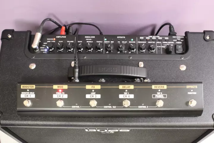 Pedal board laying on top of a guitar amplifier with a red LED indicating that the second tone is selected, just like it is shown on the amplifier