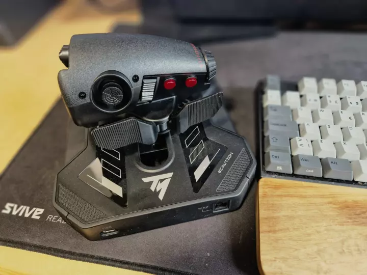 A throttle device seen from the backside with buttons, dials and switches