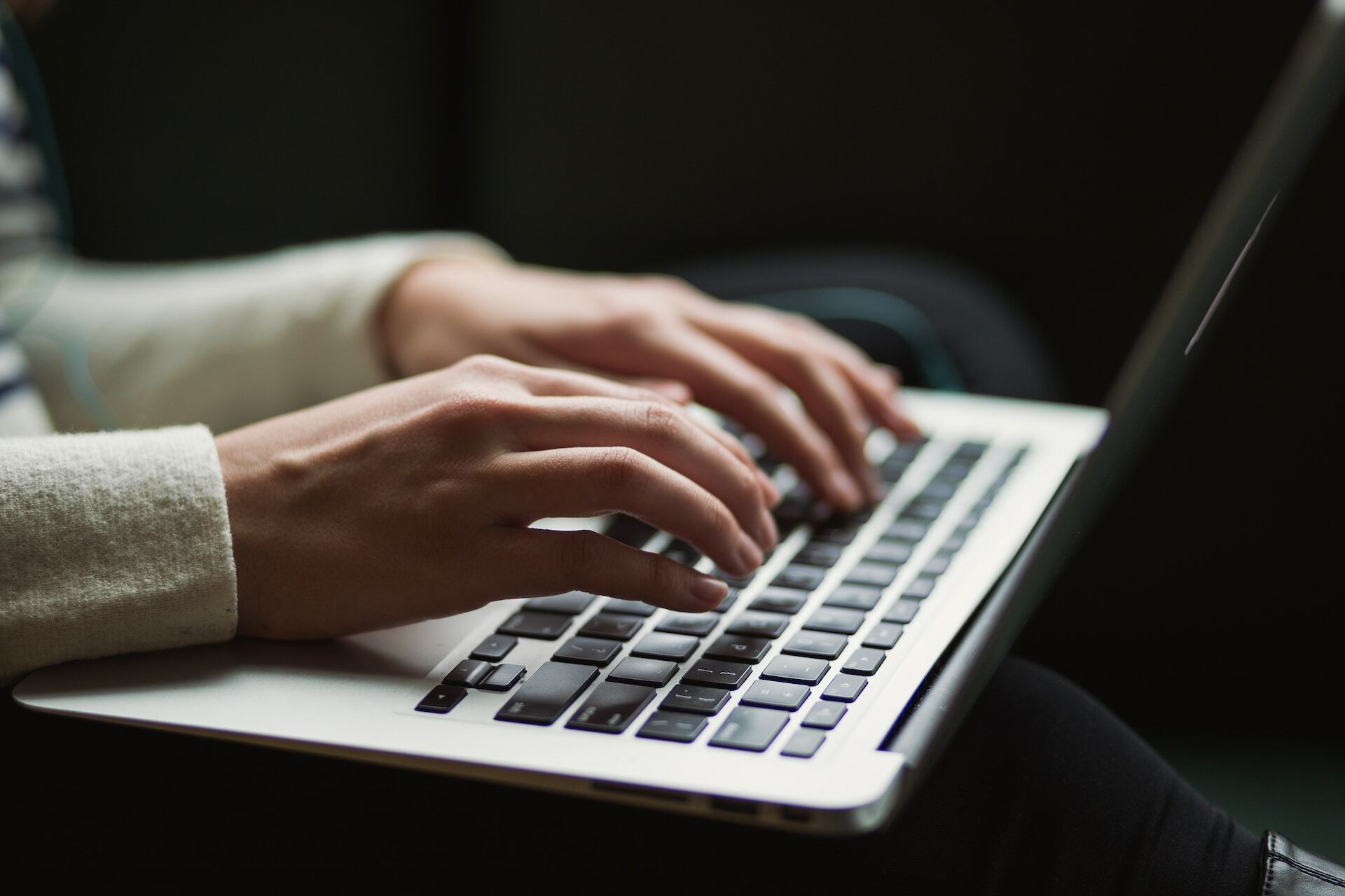 a person typing on a laptop keyboard